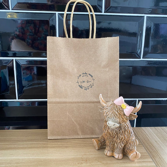 Highland cow with bow